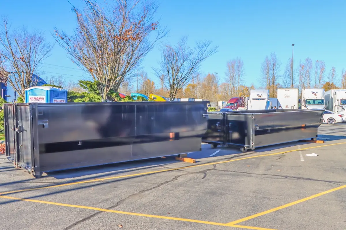 Professional dumpster rental service with roll-off container on residential driveway in Dickinson